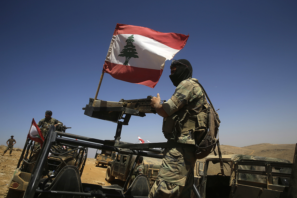 Lebanese soldiers sit on top of an armored personnel carrier during a media trip organized by the Lebanese army, on the outskirts of Ras Baalbek, northeast Lebanon, August 28, 2017. (AP/Hassan Ammar)