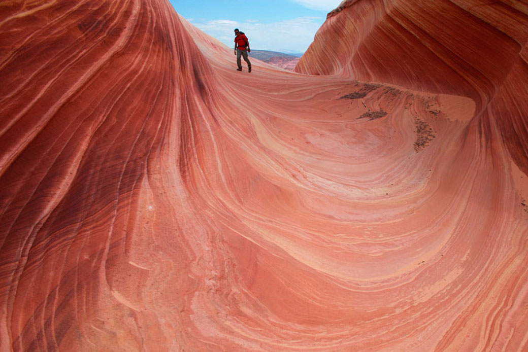A hiker walks on a rock formation in the Vermilion Cliffs in Arizona, May 28, 2013. (AP/Brian Witte)