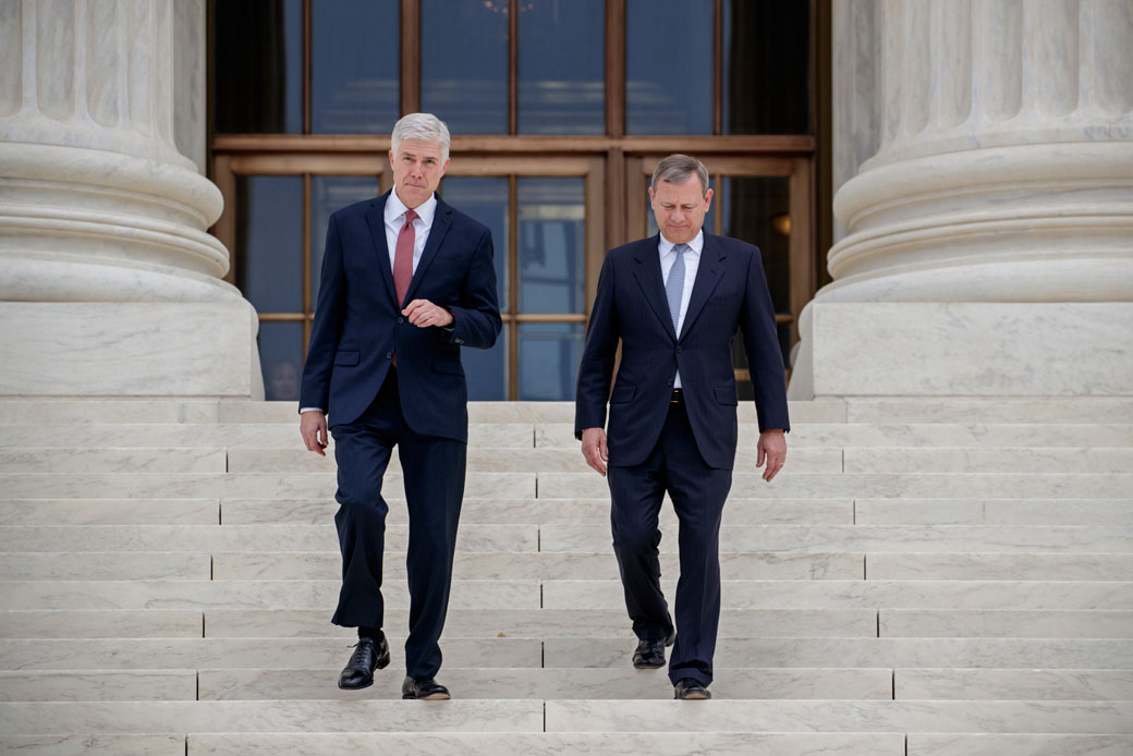 Associate Supreme Court Justice Neil Gorsuch and Chief Justice John Roberts walk down the steps of the Supreme Court in Washington, June 2017. (AP/ J. Scott Applewhite)