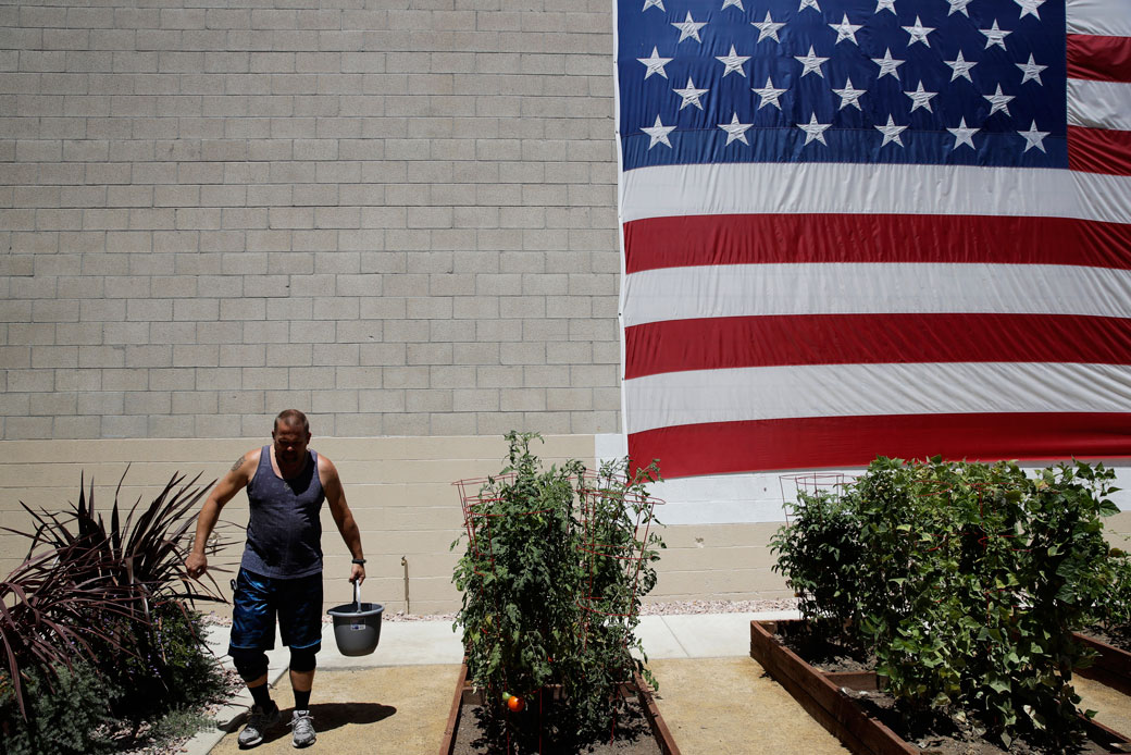 A giant American flag hangs on the wall of Potter's Lane, an apartment complex made out of recycled shipping containers just for homeless veterans, August 2017. (AP/Jae C. Hong)