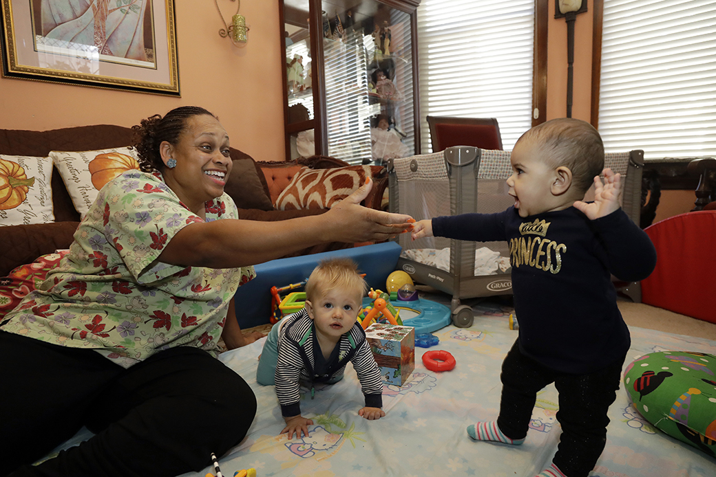 A woman cares for toddlers at her home, which has she has converted into a child care center, in Oakland, California, October 2016.