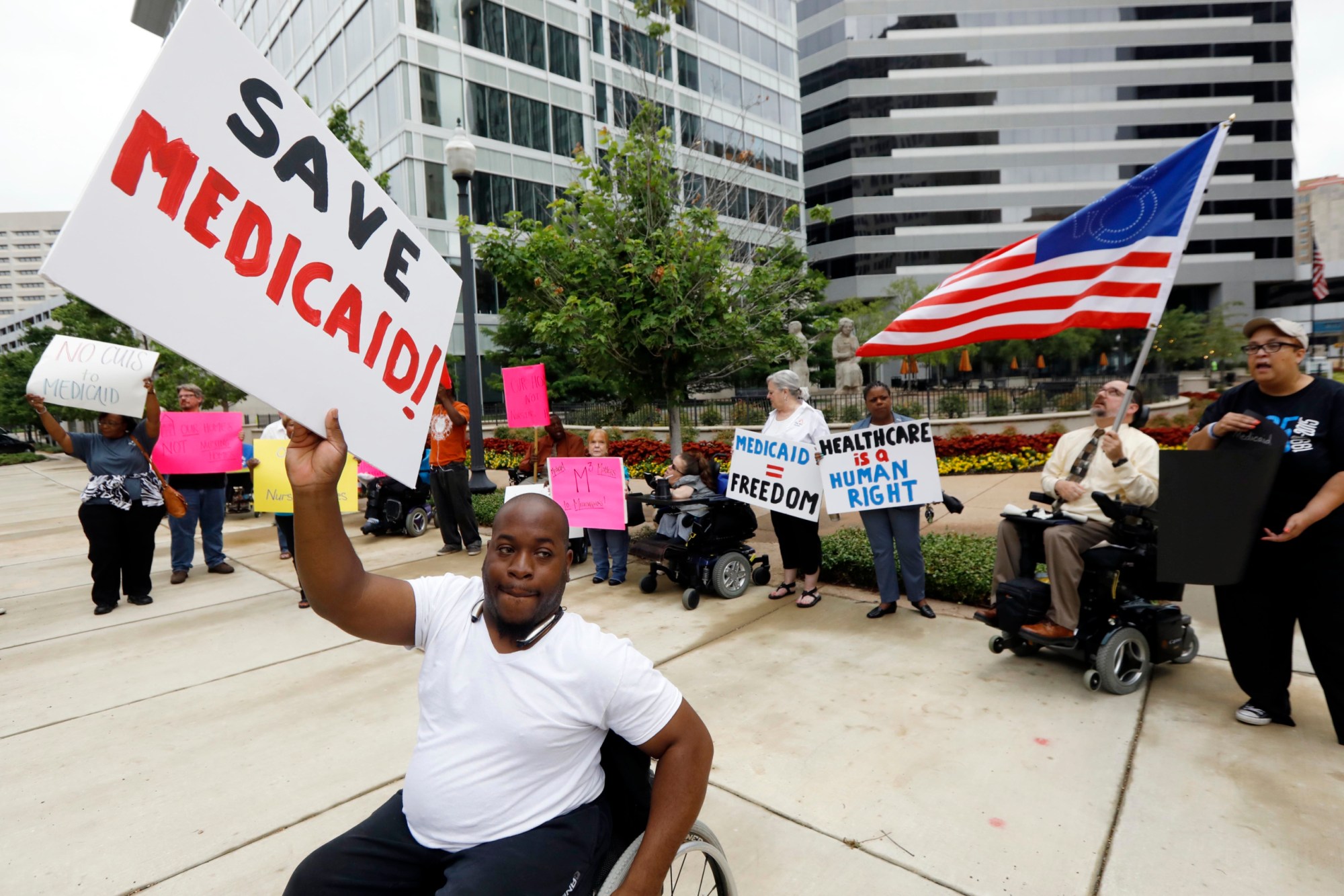 Medicaid recipients and their supporters stage a protest outside the building that houses the offices of U.S. Sen. Thad Cochran (R-MS). (AP/Rogelio V. Solis)