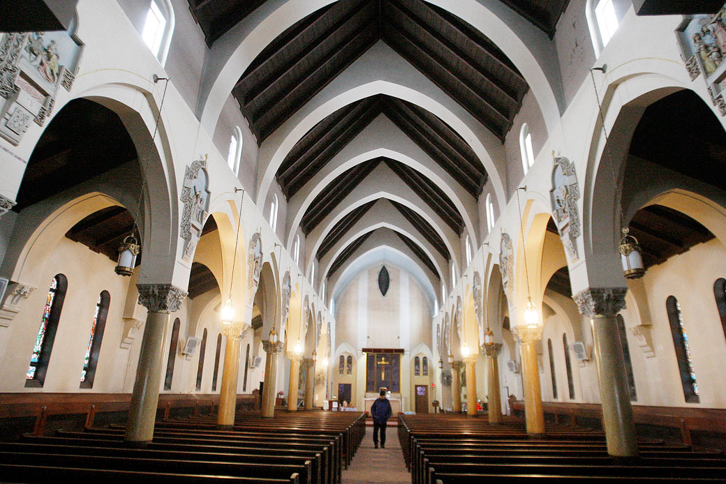 A parishioner walks up the center aisle of a church in Everett, Massachusetts, February 2009. (AP/Stephan Savoia)