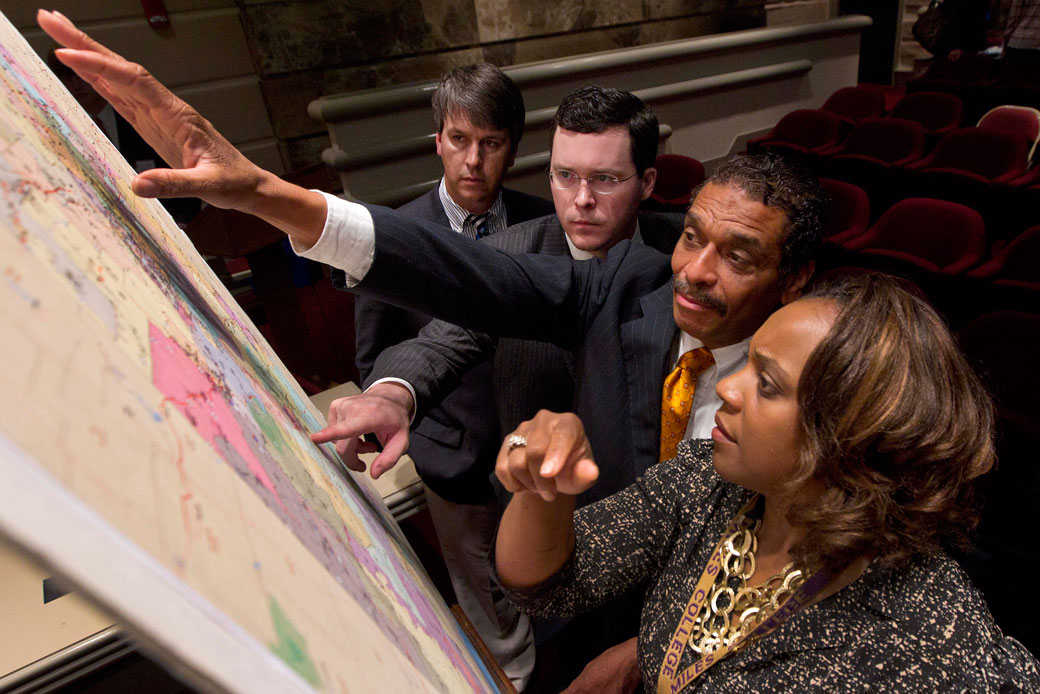 Lawmakers study a map of a proposed redistricting plan at the State House in Montgomery, Alabama, May 9, 2012. (AP/Dave Martin)