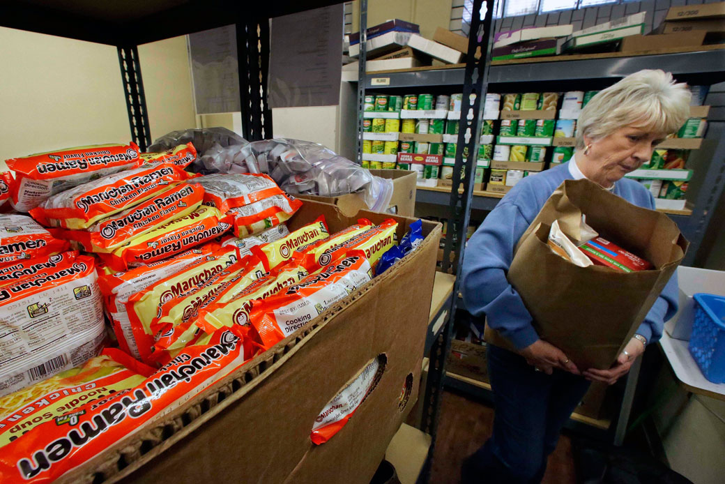 A woman prepares food supplies to be distributed to people in need in Springfield, Illinois, January 15, 2013. (AP/Seth Perlman)