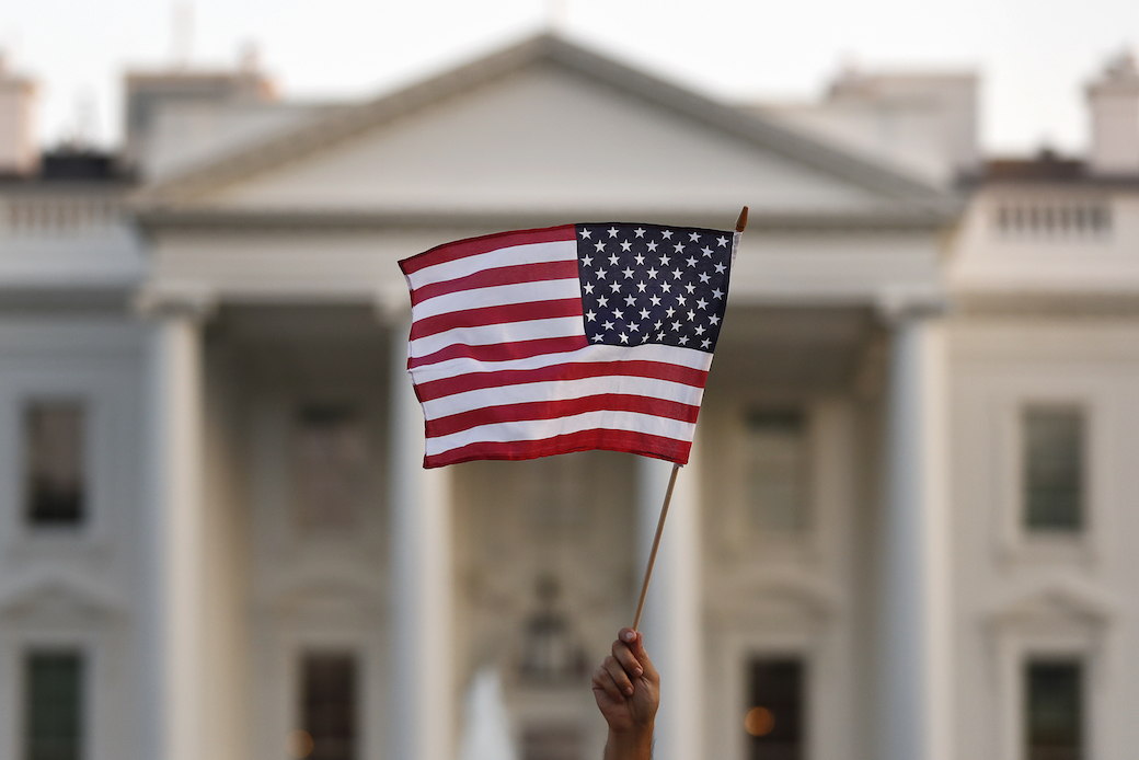 A supporter of the Deferred Action for Childhood Arrivals waves a flag during a rally at the White House in September 2017. (AP/Carolyn Kaster)