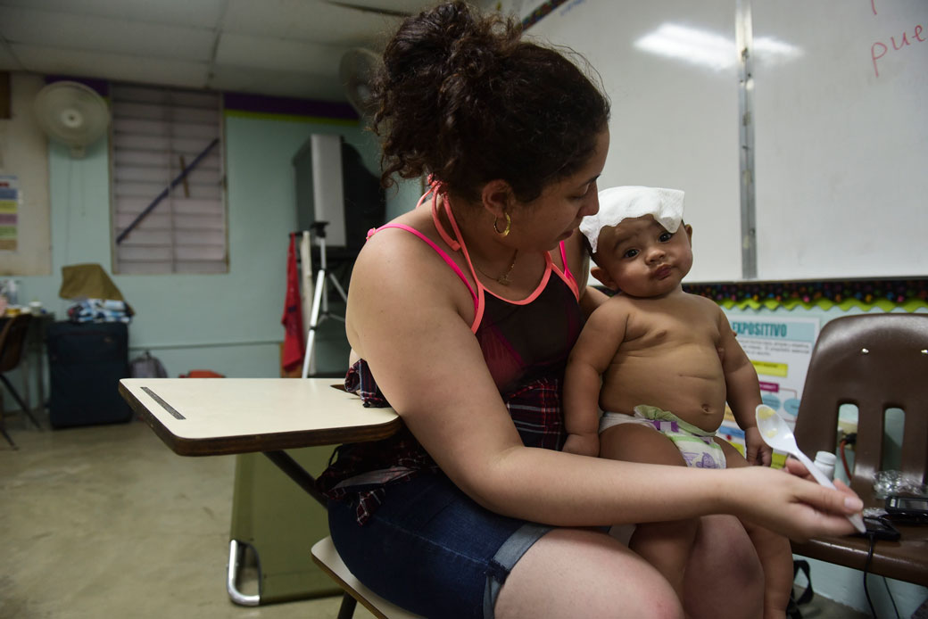 A mother and her son take refuge at an elementary school in Humacao, Puerto Rico, before the arrival of Hurricane Maria, September 19, 2017. (AP/Carlos Giusti)