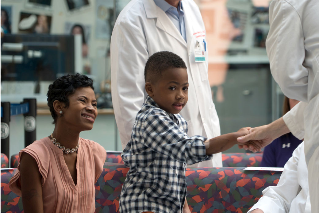 A mother watches her son shake hands with a health care worker at a Philadelphia hospital, August 23, 2016. (AP/Dake Kang)