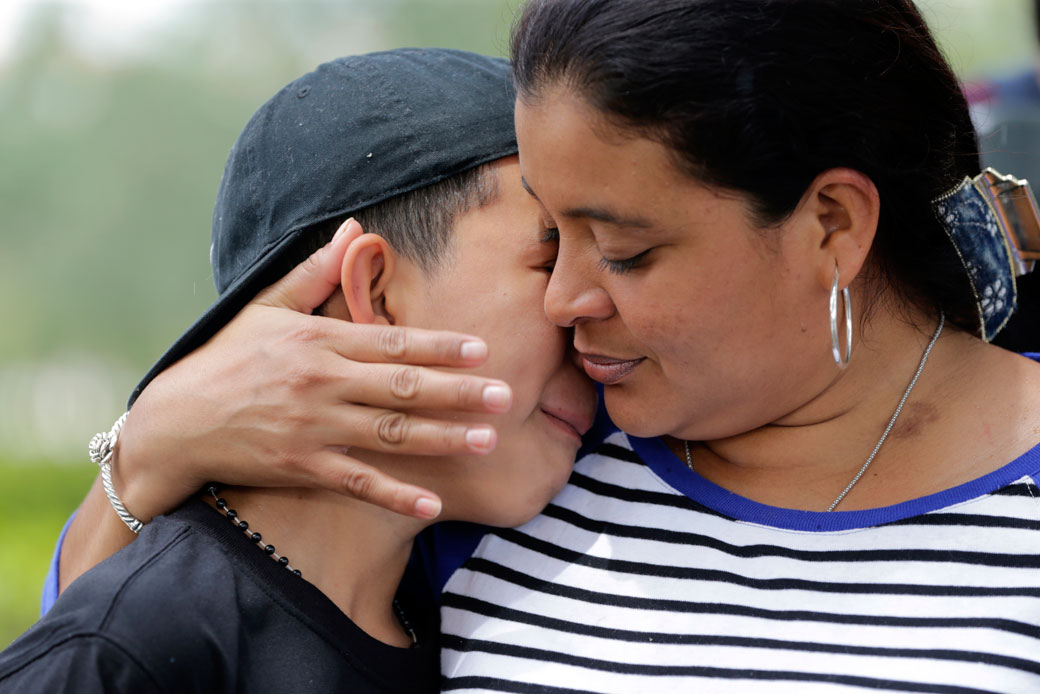 A mother embraces her son outside of the U.S. Citizenship and Immigration Services office in Miramar, Florida, May 19, 2017. (AP/Lynne Sladky)