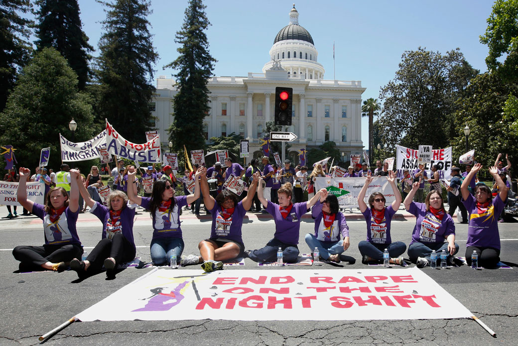 Demonstrators hold hands outside the California State Capitol in Sacramento in support of a measure aimed to protect women custodial workers, May 31, 2016. (AP/Rich Pedroncelli)