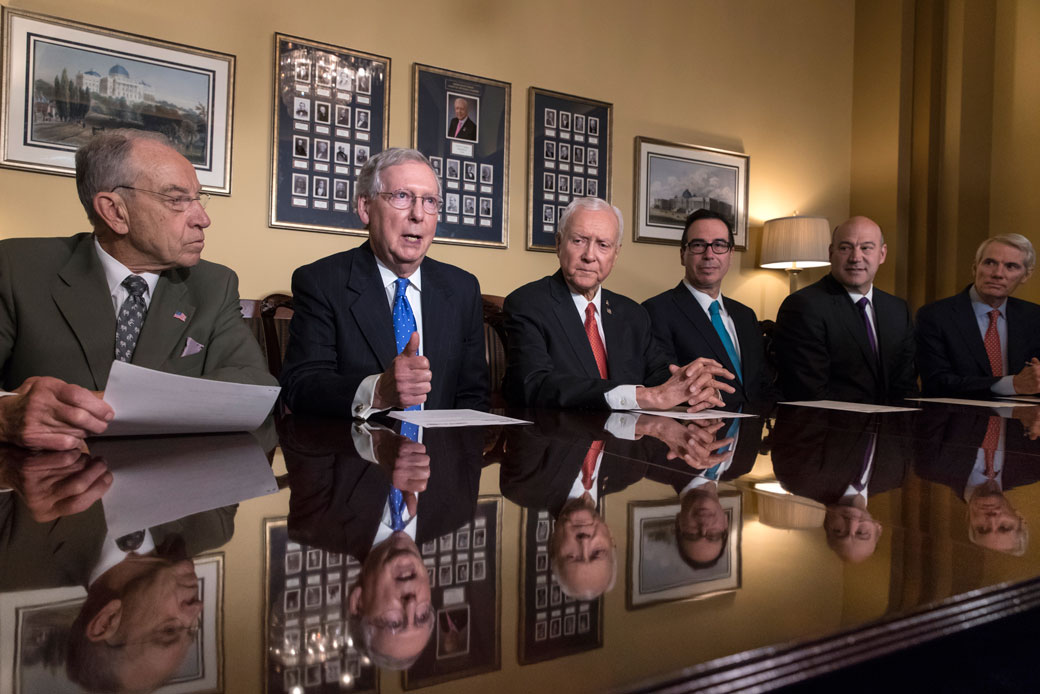 From left, Sen. Chuck Grassley (R-IA), Sen. Mitch McConnell (R-KY), Sen. Orrin Hatch (R-UT), Treasury Secretary Steven Mnuchin, President Donald Trump's top economic adviser Gary Cohn, and Sen. Rob Portman (R-OH), discuss the Senate's version of the GOP tax bill, November 2017. (AP/J. Scott Applewhite)