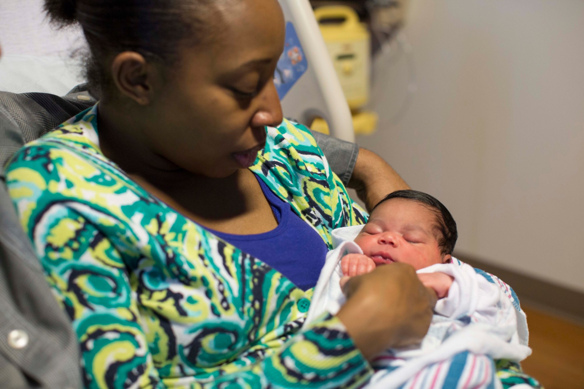 A woman holds her newborn daughter, June 2013. (AP/Scott Eisen)