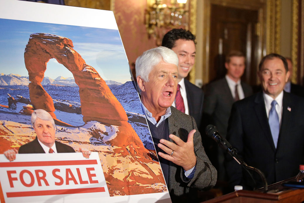 Rep. Rob Bishop (R-UT) speaks at a news conference at the Utah State Capitol while holding an image that criticizes his public lands proposal, January 2016. (AP/Rick Bowmer)