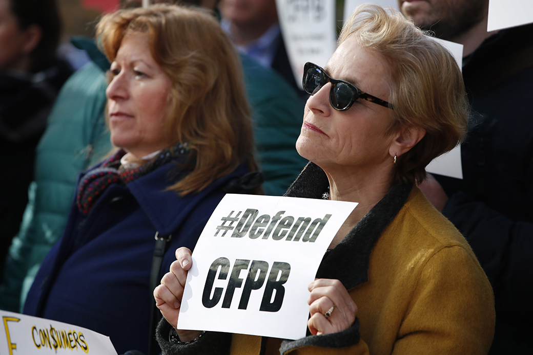 An advocate, right, holds a sign that says 