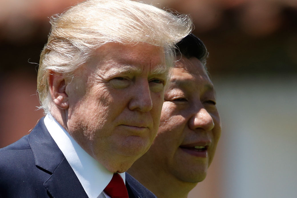 In this April 7, 2017, photo, U.S. President Donald Trump, left, and Chinese President Xi Jinping walk together at Mar-a-Lago in Palm Beach, Florida. (AP/Alex Brandon)