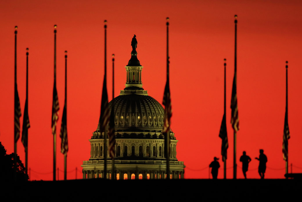 The U.S. Capitol dome as the sun rises on Tuesday, Oct. 3, 2017, at the foot of the Washington Monument on the National Mall in Washington. (AP/Manuel Balce Ceneta)