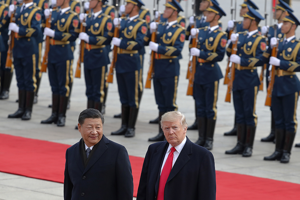U.S. President Donald Trump, right, walks with Chinese President Xi Jinping during a welcome ceremony at the Great Hall of the People in Beijing, November 9, 2017.