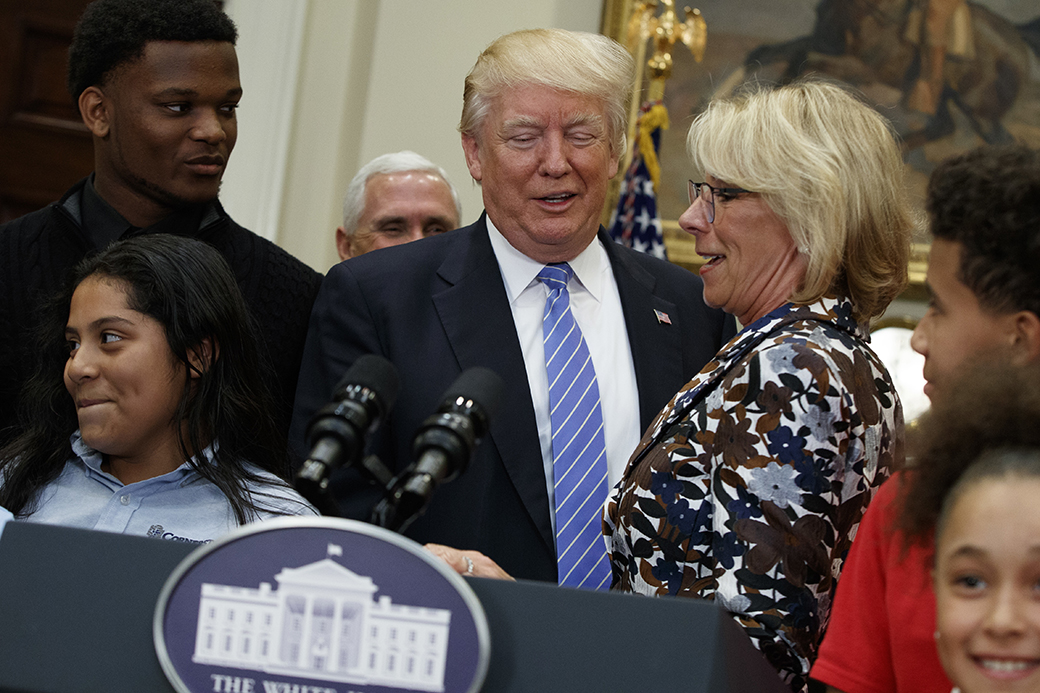 President Donald Trump stands with Education Secretary Betsy DeVos as he arrives to speak during a school choice event in the Roosevelt Room of the White House in Washington, May 3, 2017. (AP/Evan Vucci)