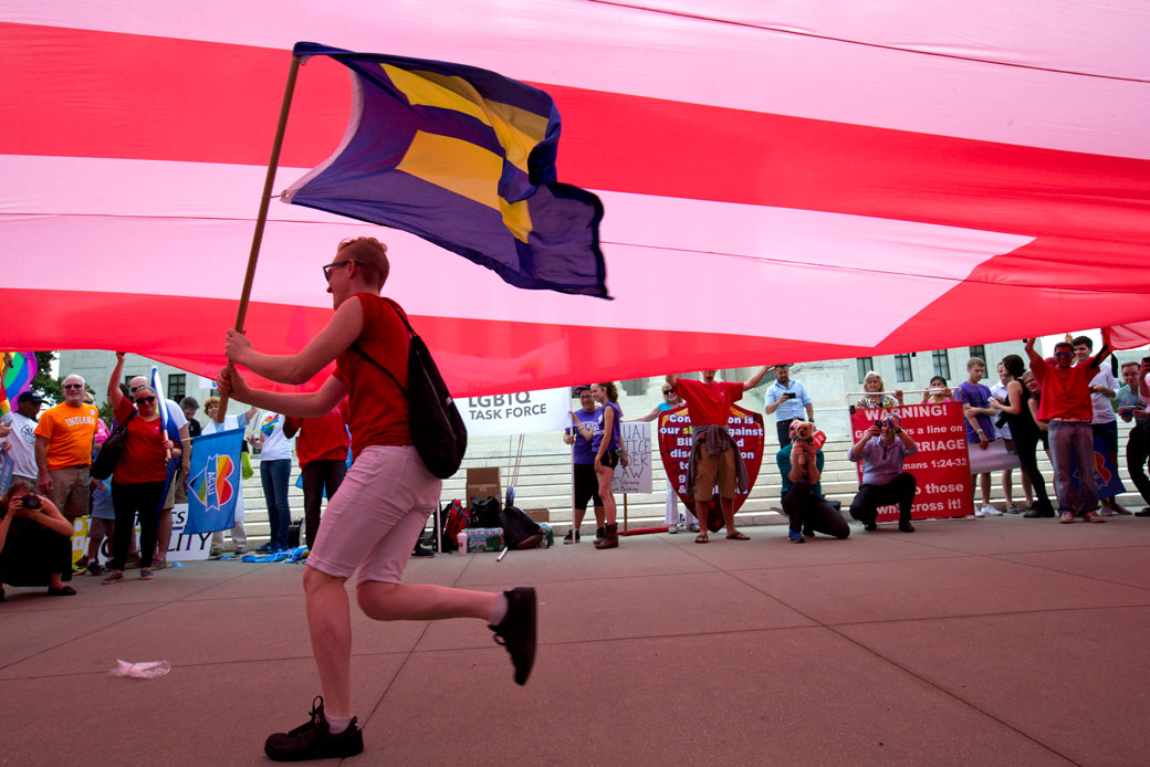 A supporter of same-sex marriage runs with an equality flag outside of the Supreme Court in Washington, June 26, 2015. (AP/Jacquelyn Martin)