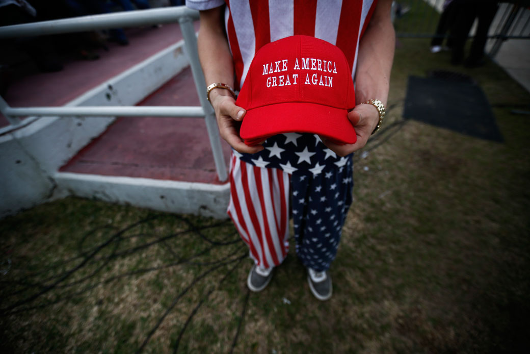 A man dressed in American flag clothes holds 