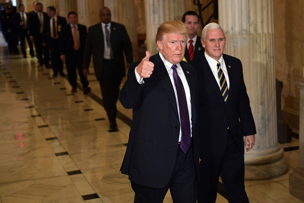 U.S. President Donald Trump gives a thumbs up as he and Vice President Mike Pence depart Capitol Hill in Washington, D.C., November 2017. (AP/Susan Walsh)