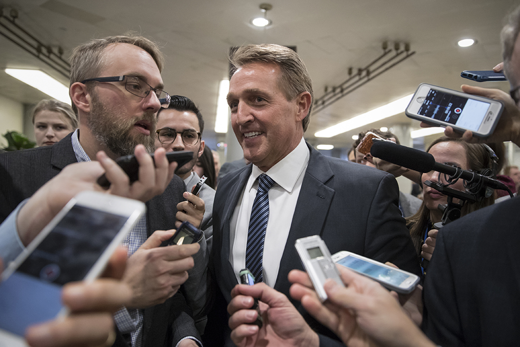 Arizona Sen. Jeff Flake, a member of the Senate Appropriations Committee, takes questions from reporters as he and other lawmakers head to the Senate floor for votes on Capitol Hill in Washington, November 27, 2017. (AP/J. Scott Applewhite)
