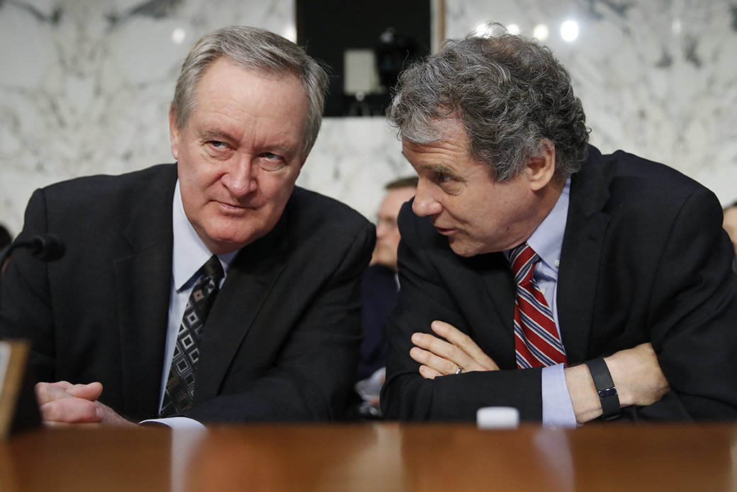 Chairman of the Senate Banking, Housing, and Urban Affairs Committee Sen. Michael Crapo (R-ID), left, and ranking member Sen. Sherrod Brown (D-OH), talk before Jerome Powell, President Donald Trump's nominee for chairman of the Federal Reserve, testifies during a Senate Banking, Housing, and Urban Affairs Committee confirmation hearing on Capitol Hill in Washington, November 28, 2017. (AP/Carolyn Kaster)
