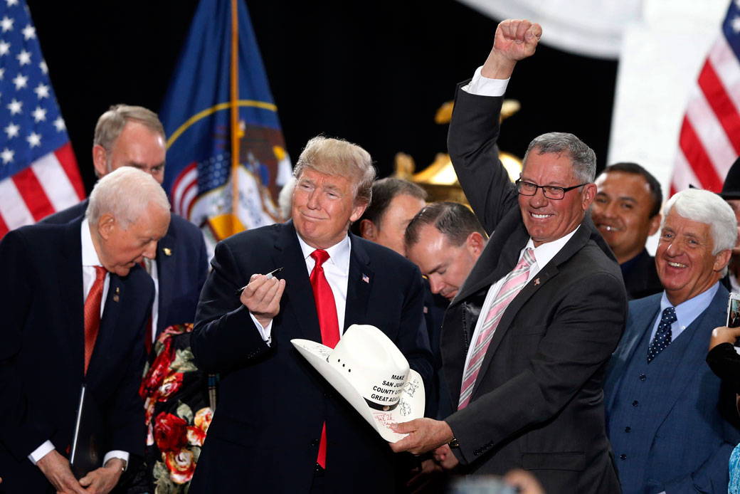 President Trump signs the hat of Bruce Adams, chairman of the San Juan County Commission, after signing a proclamation to shrink the size of Bears Ears and Grand Staircase-Escalante national monuments in Salt Lake City, December 4, 2017. (AP/Rick Bowmer)