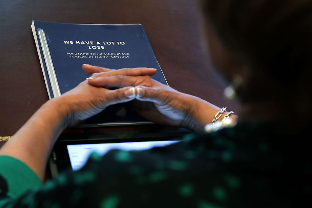 WASHINGTON, DC - MARCH 22:  (AFP OUT) Congressional Black Caucus Executive Committee member Rep. Brenda Lawrence (D-MI) has a copy of a report titled 'We Have A Lot To Lose' during a meeting with U.S. President Donald Trump in the Cabinet Room at the White House March 22, 2017 in Washington, DC. During the 2016 presidential campaign, Trump asked African Americans to support him, saying, 