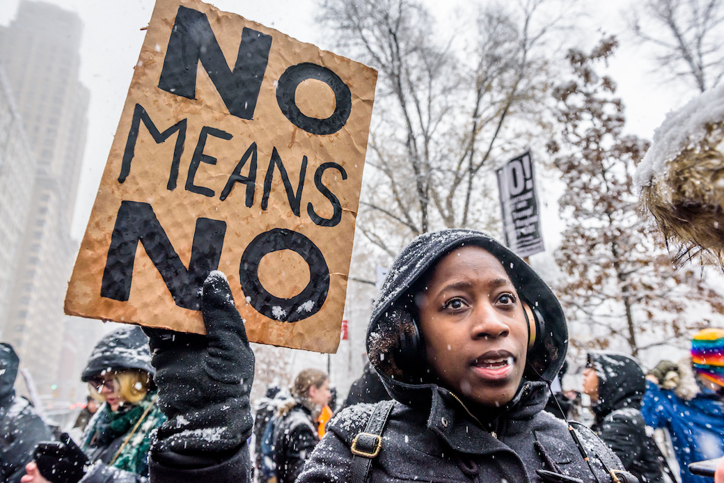 A protestor joins the #MeToo rally against sexual harassment outside Trump International Hotel in New York City, December 9, 2017. (Getty/Pacific Press, Erik McGregor)