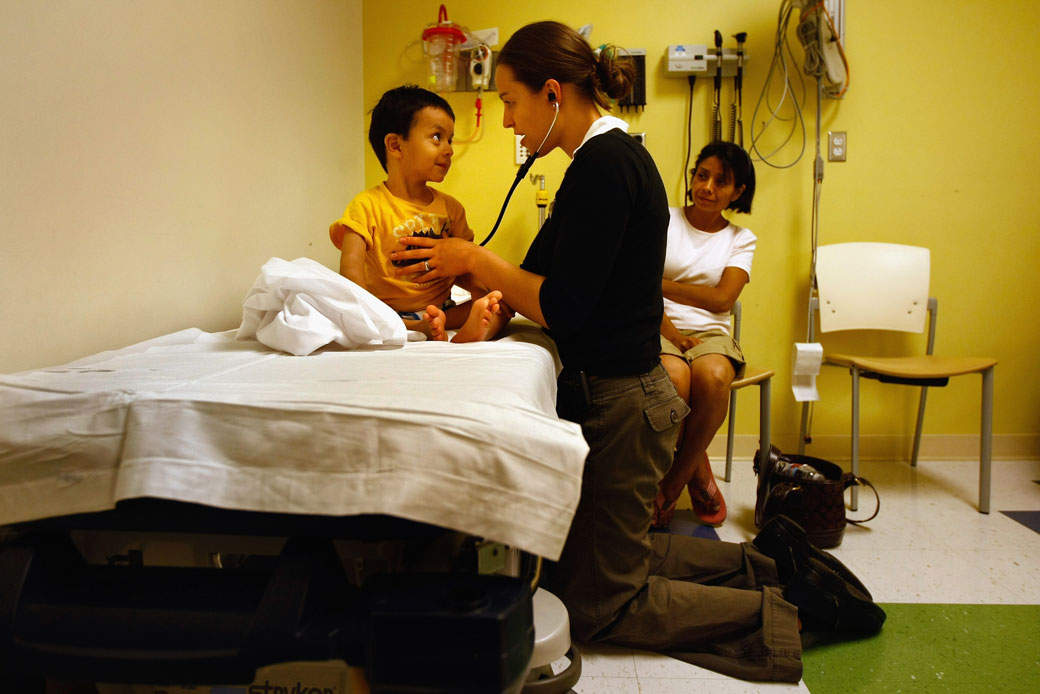 A resident nurse checks the heart rate of a child, September 2009. (Getty/John Moore)