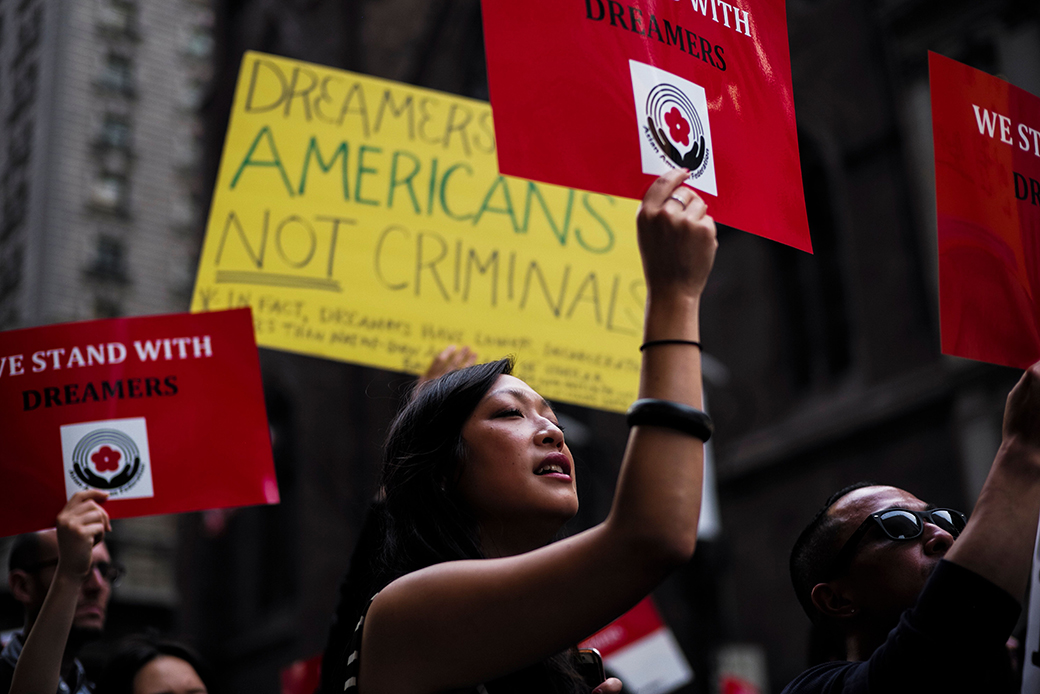 Protesters hold up signs during a rally in support of Deferred Action for Childhood Arrivals, near Trump Tower in New York, October 5, 2017. (Getty/AFP, Jewel Samad)