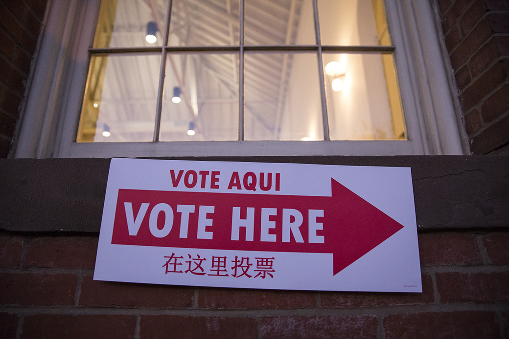A sign directing voters to the polling center is seen on a wall in Eastern Market as the sun rises on the 2016 presidential election in Washington, November 8, 2016. (Getty/Anadolu Agency, Samuel Corum)