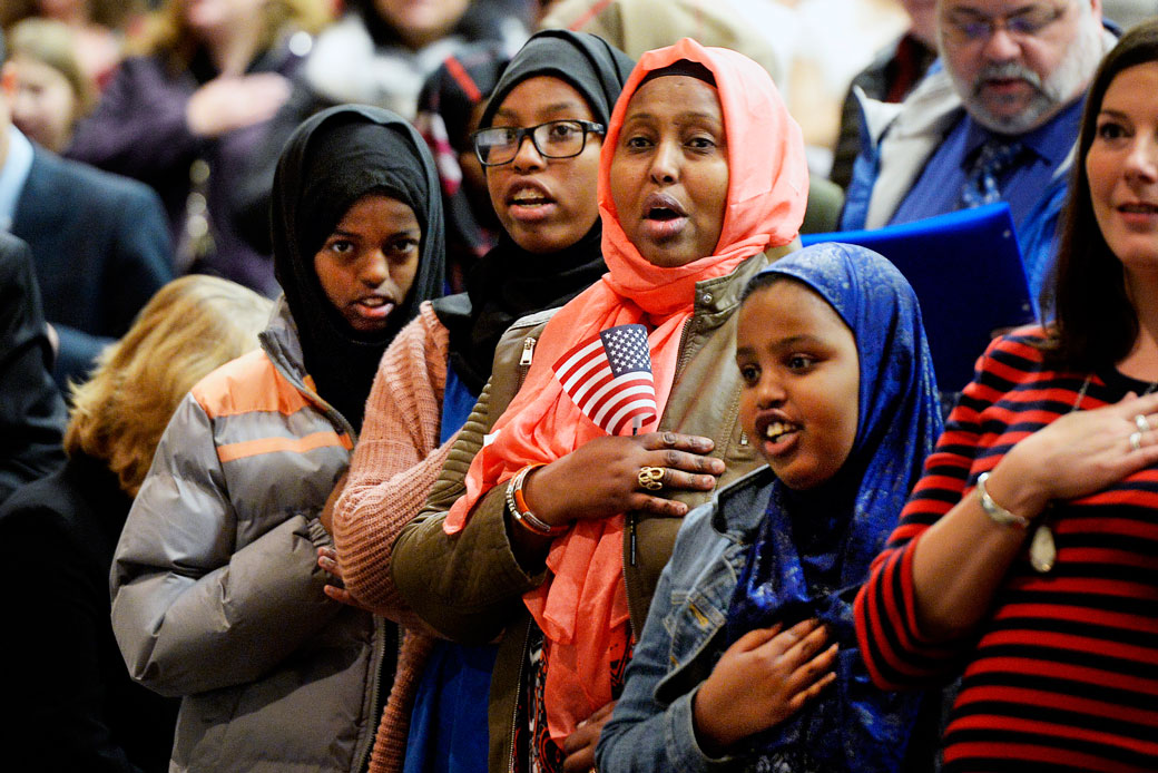 Bahga Guelleh and her daughters pledge allegiance to the flag during a naturalization ceremony, January 2018. (AP/Shawn Patrick Ouellette)