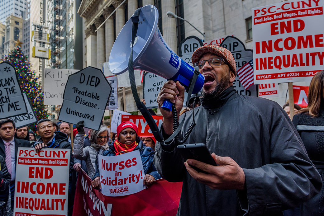 People rally against the Trump tax bill outside the New York Stock Exchange on December 19, 2017. (Getty/Pacific Press/LightRocket/Erik McGregor)