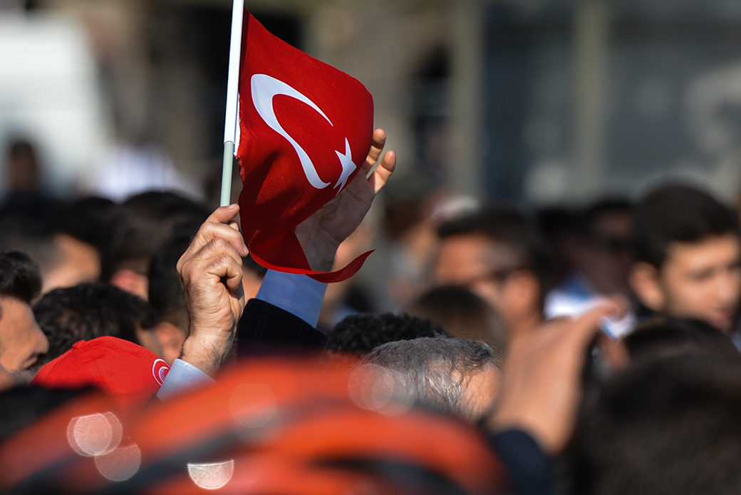 A person waves a Turkish national flag in the crowd in the Fatih area near Blue Mosque, October 17, 2017, in Istanbul. (Getty/NurPhoto/Artur Widak)
