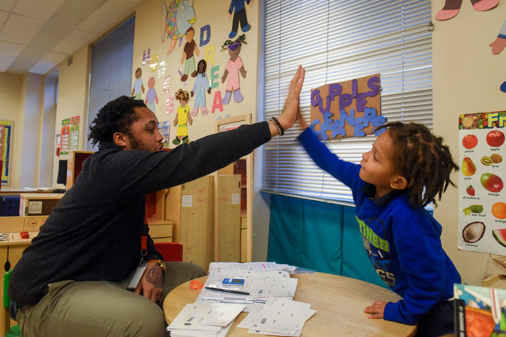 A student high-fives his teacher in a Washington, D.C., classroom, on January 23, 2016. (Getty/Washington Post)