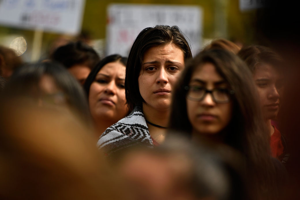 Students listen to stories of parents and families as immigrants and affected individuals march to defend the Deferred Action for Childhood Arrivals (DACA) program in downtown Denver, September 5, 2017. (Getty/Joe Amon)