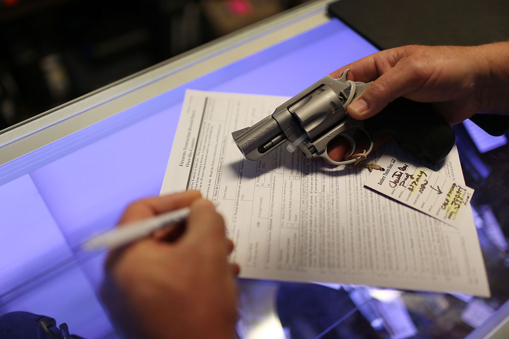 A man in Florida fills out background check paperwork as he purchases a handgun, January 2016. (Getty/Joe Raedle)