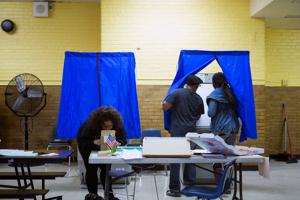 A woman enters a voting booth to cast her vote at Vare Edwin Middle School on November 8, 2016, in South Philadelphia, Pennsylvania. (Getty/Jessica Kourkounis)