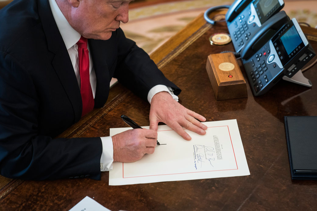 President Donald Trump signs the Tax Cut and Reform Bill, a $1.5 trillion tax overhaul package, into law in the Oval Office at the White House in Washington, D.C., on Friday, December 22, 2017. (Getty/Jabin Botsford/The Washington Post)