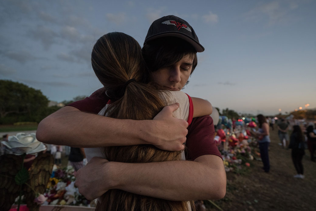 Two students hug at Marjory Stoneman Douglas High School in Parkland, Florida, on February 25, 2018. (Getty/Giles Clarke)