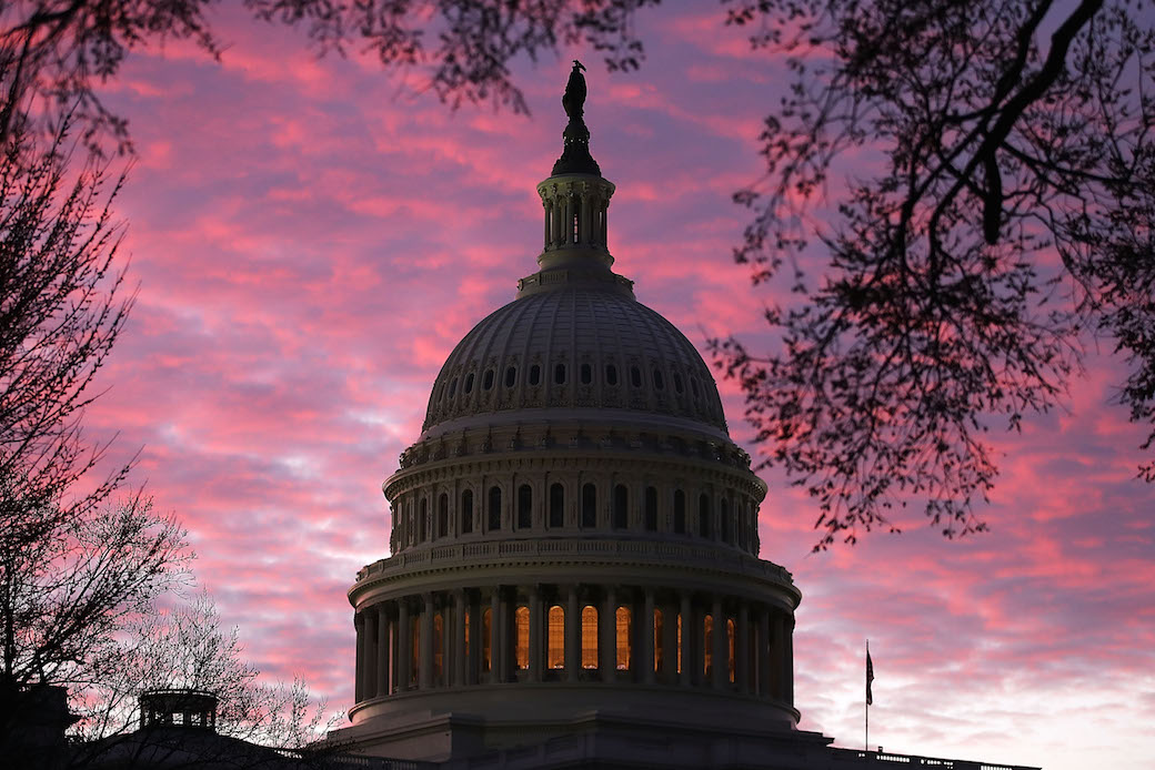 The sun rises behind the U.S. Capitol in Washington, D.C., March 6, 2018. (Getty/Mark Wilson)