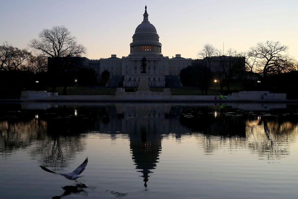 The U.S. Capitol casts early morning reflections on the day that the House and Senate voted on President Donald Trump's tax cut bill, December 19, 2017. (Getty/Mark Wilson)