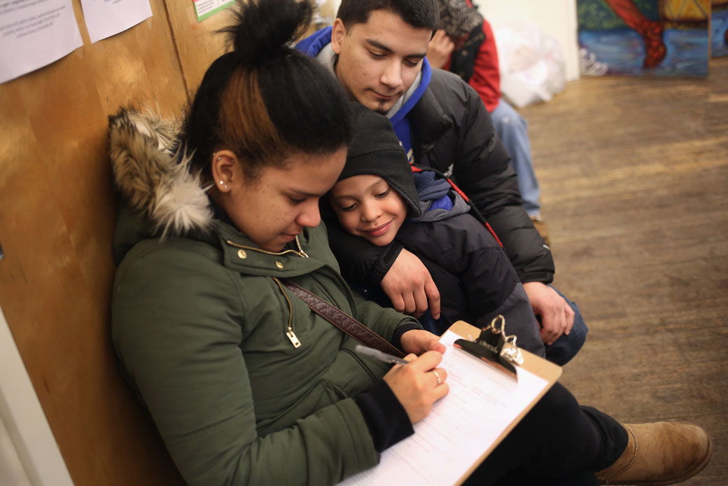 A family fills out an application for DACA at a workshop in New York City, February 2015. (Getty/John Moore)