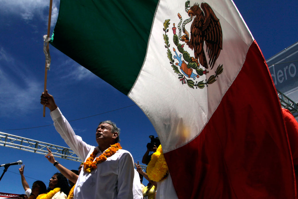 Andrés Manuel López Obrador, who currently has a significant lead in the polls for the 2018 Mexican presidential election, waves the Mexican national flag at a rally in Acapulco, Mexico, June 2012. (Getty/Pedro Pardo)