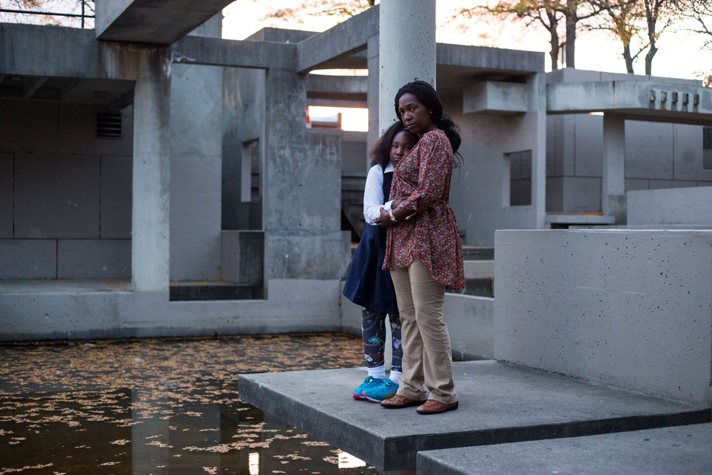 A mother and her daughter stand at a now defunct water fountain in downtown Flint, Michigan, on October 11, 2016. (Brittany Greeson/Getty)