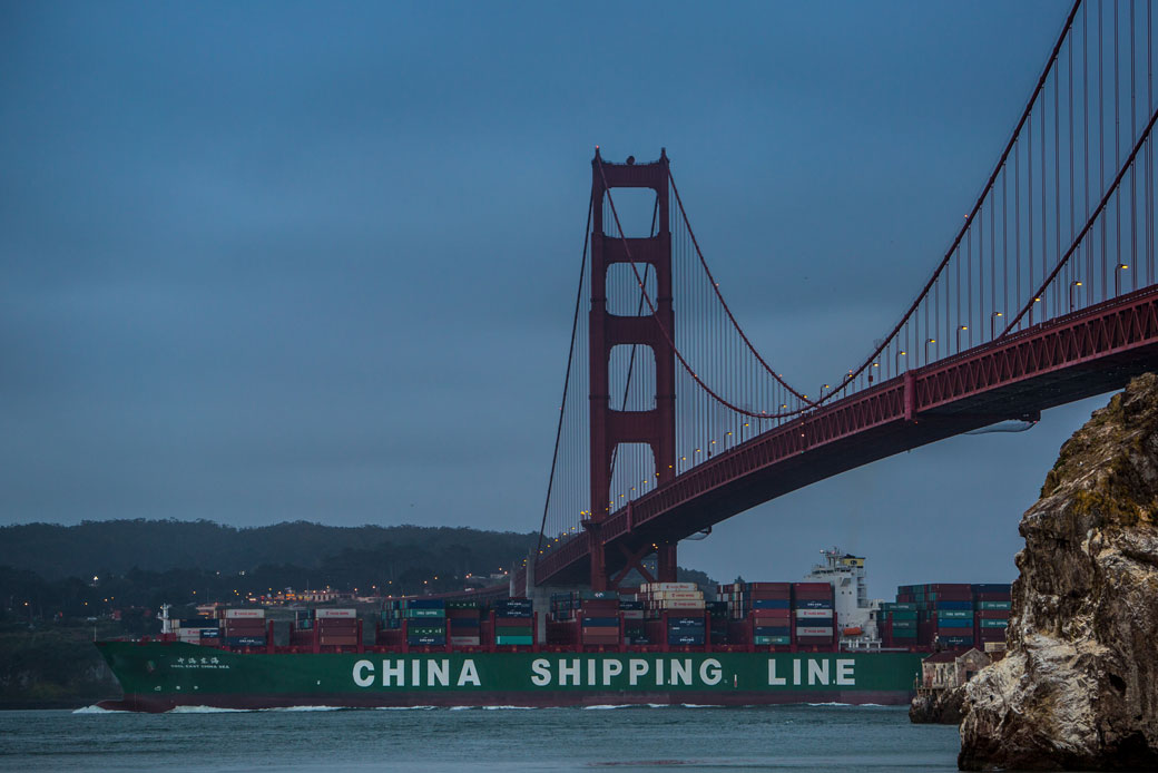 A Chinese container ship passes under the Golden Gate Bridge before sunrise in San Francisco, June 2015. (Getty/George Rose)
