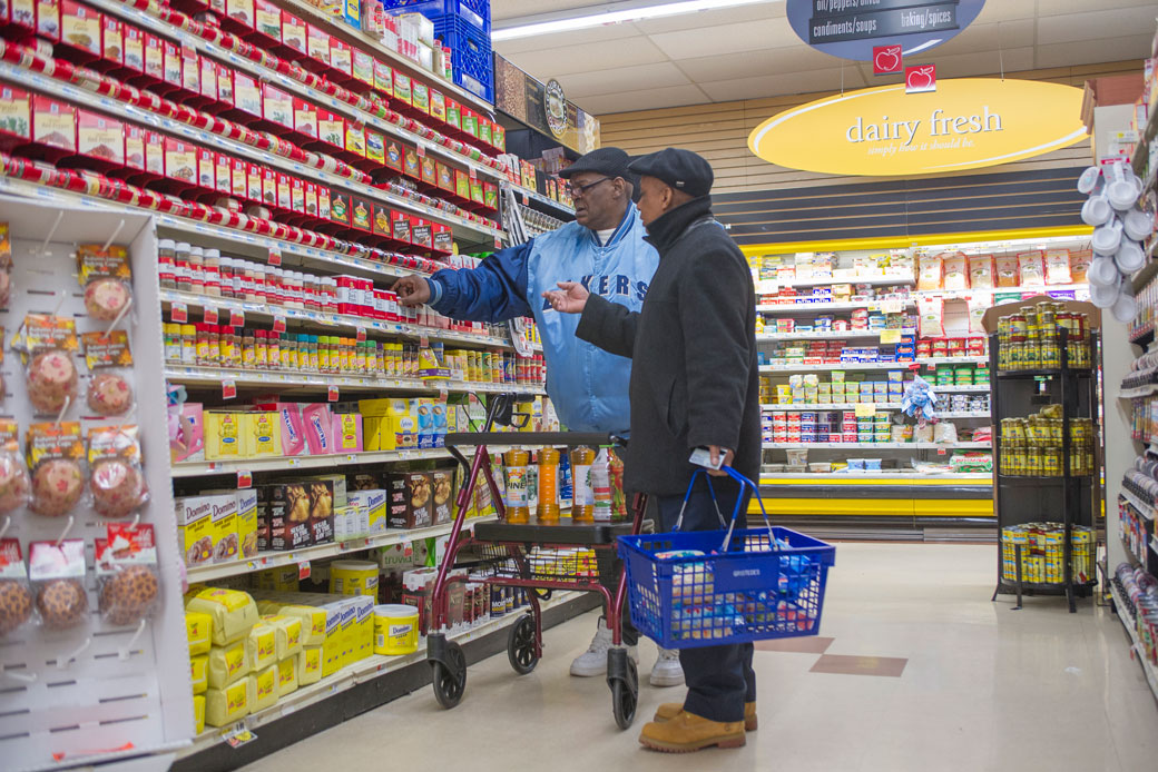 A man with a walker shops for groceries in a supermarket, November 2013. (Getty/Education Images/Universal Images Group)