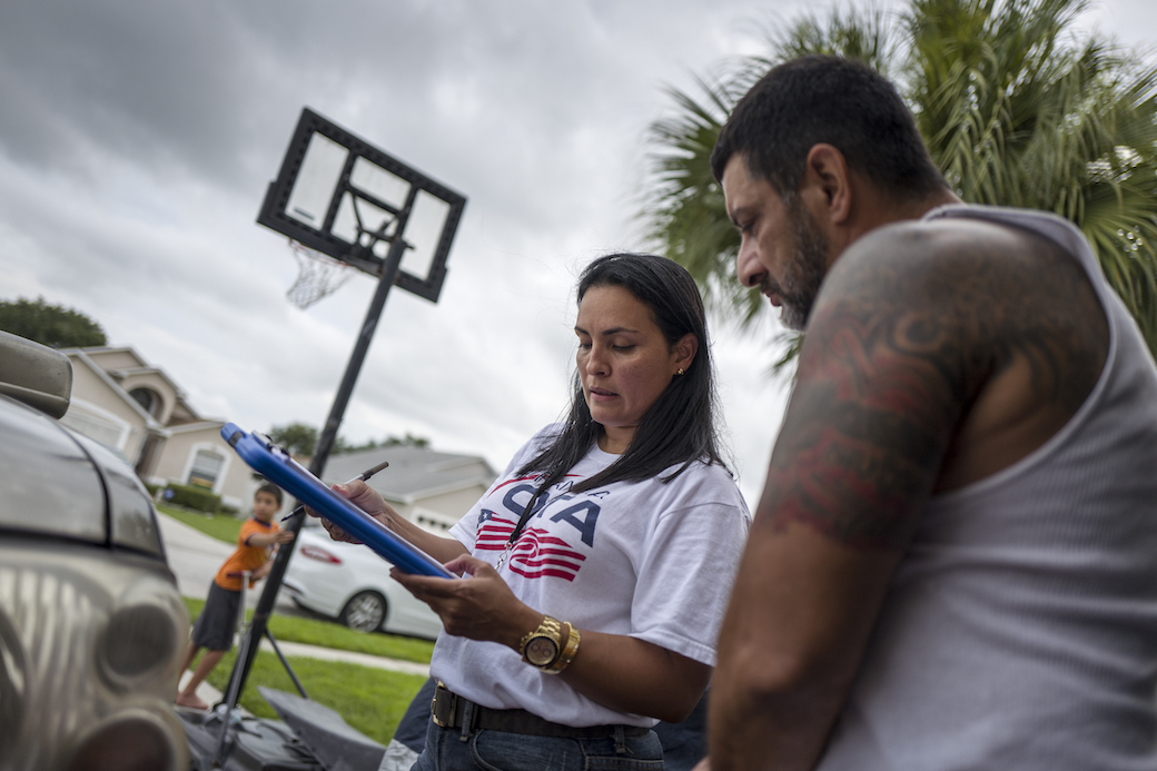 A state coordinator for Mi Familia Vota helps Latinos register to vote ahead of the 2016 presidential election in Kissimmee, Florida, July 2016. (Getty/Charles Ommanney/The Washington Post)
